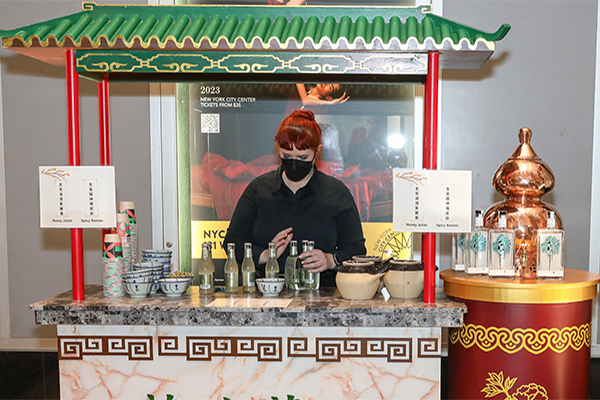  Prior to the opening performance, the Hong Kong Economic and Trade Office, New York, organized a reception bringing guests on a Hong Kong retro tour by exhibiting some of the city's cultural heritage, including Lam Tsuen Wishing Trees, herbal tea shop, and mahjong game set, etc. 